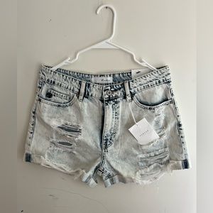 A pair of blue denim high waisted shorts from Kancan.